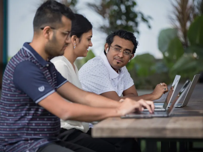 A team working together at laptops
